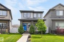 Two-story dwelling with gray horizontal siding and black trim windows - 17733 64A Street, Edmonton, AB 