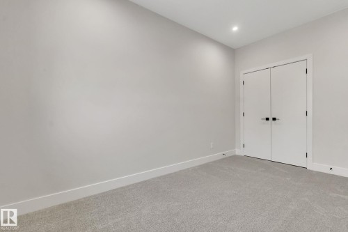 Room featuring light gray carpeting, white baseboards, and neutral wall paint - 11132 72 Avenue, Edmonton, AB - Indoor Photo Showing Other Room