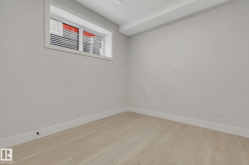 Bright room featuring light wood-finish flooring, crisp white baseboards, and a recessed window with a deep sill - 11132 72 Avenue, Edmonton, AB - Indoor Photo Showing Other Room