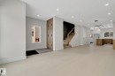 Bright open-concept living area featuring light wood-finish flooring, recessed lighting, and a modern chandelier - 11132 72 Avenue, Edmonton, AB  - Indoor Photo Showing Other Room 