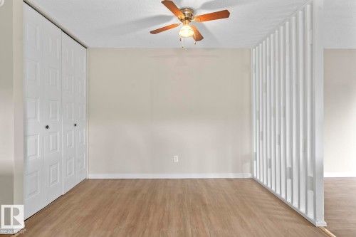 Neutral wall finishes complemented by wood-finish flooring - 210 22 Street, Cold Lake, AB 