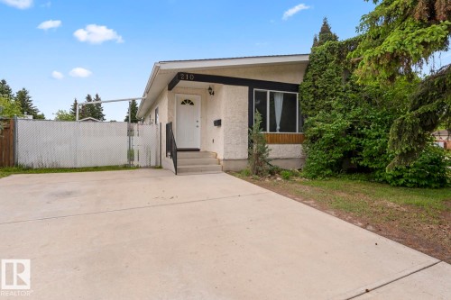 Stucco exterior residence with a concrete driveway - 210 22 Street, Cold Lake, AB 