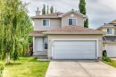 Two-story residence featuring light-toned siding and a brown shingled roof - 3711 22A St, Edmonton, AB 