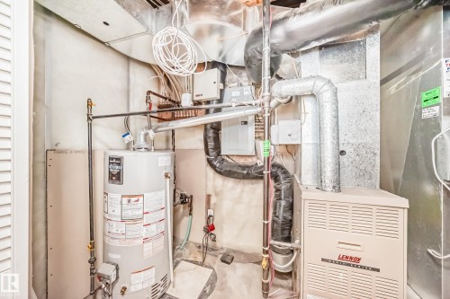 Utility area featuring a water heater and a Lennox furnace unit - 3711 22A St, Edmonton, AB 