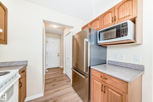 Kitchen area featuring light wood cabinetry and light-toned countertops - 3711 22A St, Edmonton, AB 