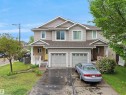 Two-story duplex featuring neutral siding and white trim - 21316 45A Avenue Nw, Edmonton, AB 