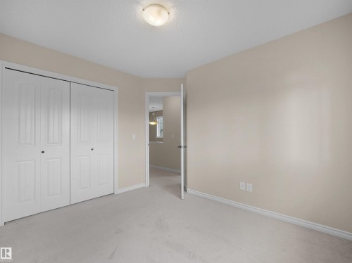 Interior room featuring neutral wall paint, white baseboards, and light-colored carpet flooring - 21316 45A Avenue Nw, Edmonton, AB 
