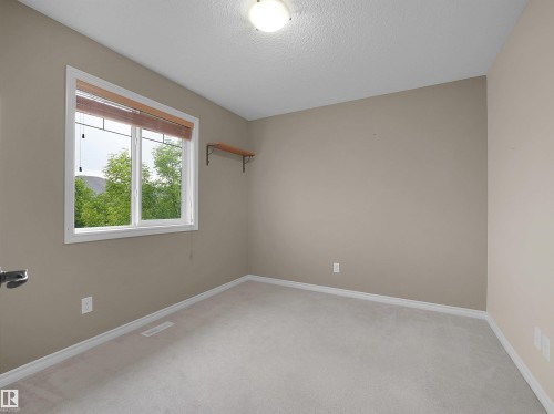 Neutral-toned interior with light grey carpet flooring and white baseboards - 21316 45A Avenue Nw, Edmonton, AB 