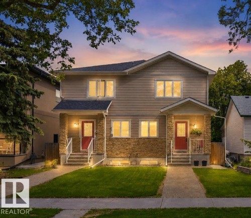 Duplex property featuring a composite shingle roof, stone and siding exterior, red entry doors, white-railed front steps, and landscaped front yards with concrete pathways - 8506 80 Avenue, Edmonton, AB 