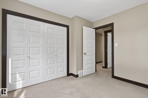 Light beige walls contrasting with dark trim and white paneled doors - 8506 80 Avenue, Edmonton, AB 