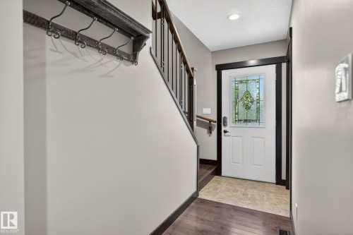 Entryway featuring a white door with decorative leaded glass, dark wood trim, and recessed lighting - 8506 80 Avenue, Edmonton, AB 