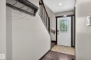 Entryway featuring a white door with decorative leaded glass, dark wood trim, and recessed lighting - 8506 80 Avenue Nw, Edmonton, AB  - Indoor Photo Showing Other Room 