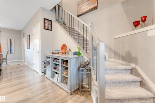 Staircase featuring carpeted treads, painted balusters, and a contemporary railing - 2652 Maple Way, Edmonton, AB - Indoor Photo Showing Other Room