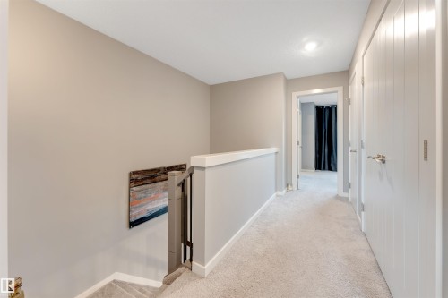 Carpeted upper-level hallway with neutral wall tones and white trim - 2652 Maple Way, Edmonton, AB - Indoor Photo Showing Other Room
