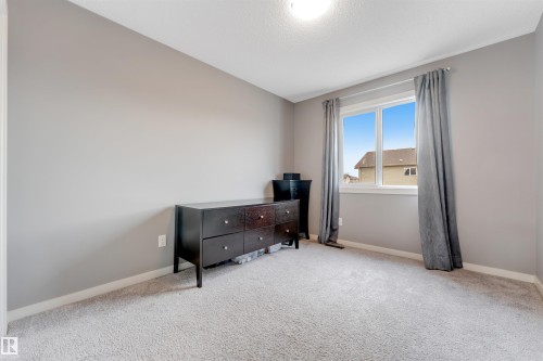 Windowed room featuring light gray walls and plush gray carpeting - 2652 Maple Way, Edmonton, AB - Indoor Photo Showing Bedroom