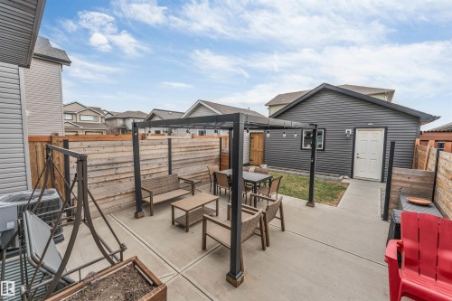 Spacious concrete patio featuring a black pergola with string lighting - 2652 Maple Way, Edmonton, AB - Outdoor With Deck Patio Veranda With Exterior