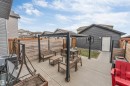 Spacious concrete patio featuring a black pergola with string lighting - 2652 Maple Way, Edmonton, AB  - Outdoor With Deck Patio Veranda With Exterior 