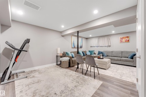 Finished lower level featuring recessed lighting, light gray walls, wood-finish flooring, and white trim - 2652 Maple Way, Edmonton, AB - Indoor Photo Showing Basement