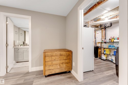 Wood-finish flooring throughout, with a neutral wall palette - 2652 Maple Way, Edmonton, AB - Indoor Photo Showing Other Room