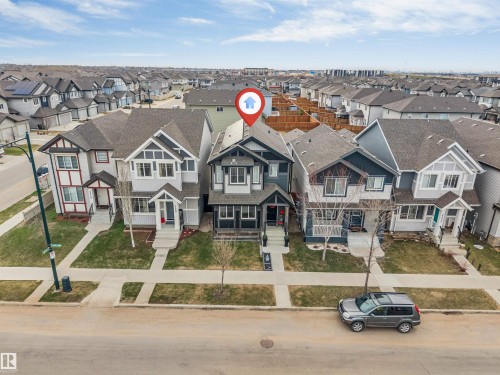 Modern two-story residence with a dark gray and white exterior featuring a gabled roofline - 2652 Maple Way, Edmonton, AB - Outdoor With Facade