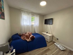 Bedroom featuring wood-finish flooring and a ceiling-mounted light fixture - 