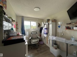 Room featuring wood-finish flooring, a window with natural light, and a ceiling-mounted light fixture - 
