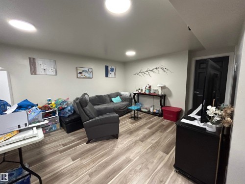 Finished space featuring recessed ceiling lighting, light-toned walls, and wood-finish flooring - 10924 30 Street, Edmonton, AB 