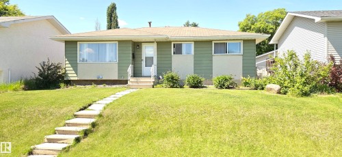 Ranch-style exterior with green siding and cream accents - 10924 30 Street, Edmonton, AB 