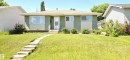 Ranch-style exterior with green siding and cream accents - 10924 30 Street, Edmonton, AB 