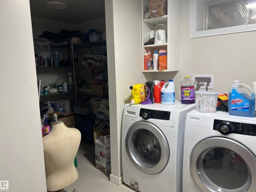 Laundry area with white walls and light-toned flooring - 10924 30 Street, Edmonton, AB 