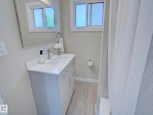 Modern bathroom vanity with a white countertop and an integrated sink - 9909 157 Street, Edmonton, AB 