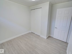 Neutral-toned room featuring light wood-finish flooring - 