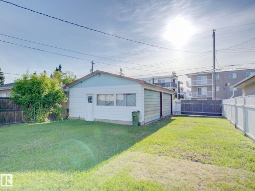 Detached garage with light blue siding and a brown trim roofline - 9909 157 Street, Edmonton, AB 
