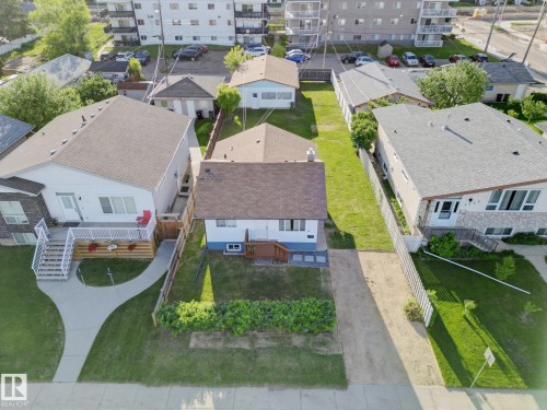 Property featuring a front yard with established landscaping and a paved driveway - 9909 157 Street, Edmonton, AB 