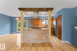 Kitchen island with a light-toned brick-finish base and wood-finish countertop - 