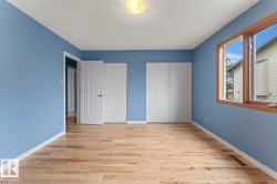 Hardwood flooring and a cased window with wood trim - 