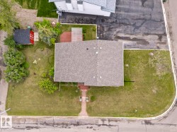 Corner lot property with a shingle roof residence - 