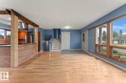 Open-concept living space with light wood-finish flooring - 
