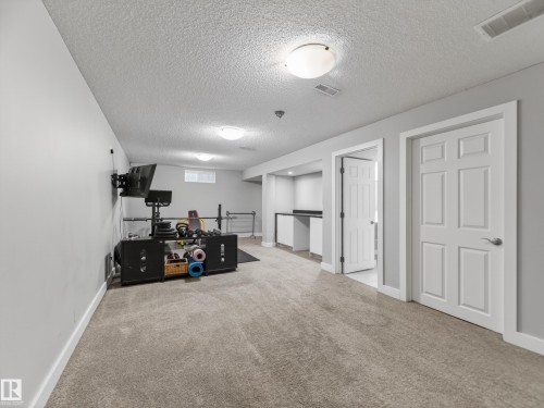 Spacious lower level featuring plush carpeting and neutral wall tones - 15803 83 Avenue, Edmonton, AB 
