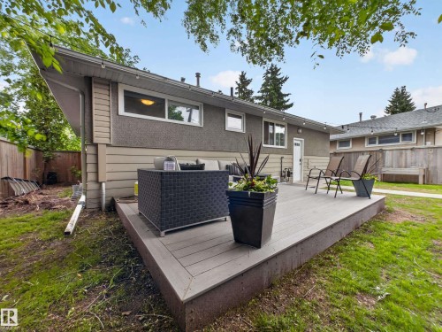 Expansive backyard featuring a composite deck, mature trees, and a privacy fence - 15803 83 Avenue, Edmonton, AB 