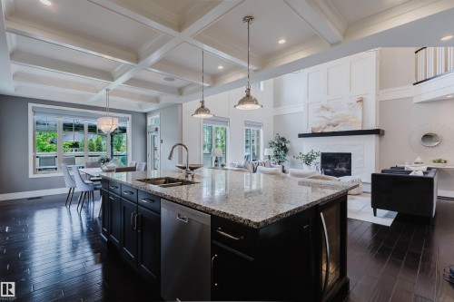 Kitchen island featuring a double basin sink and a built-in dishwasher - 3435 Keswick Boulevard, Edmonton, AB 