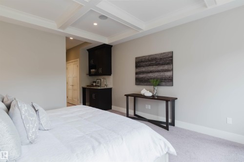 Recessed lighting illuminates a coffered ceiling, complementing the light gray wall finish - 3435 Keswick Boulevard, Edmonton, AB 