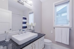 Bathroom vanity featuring a rectangular vessel sink, dark speckled countertop, and chrome faucet - 