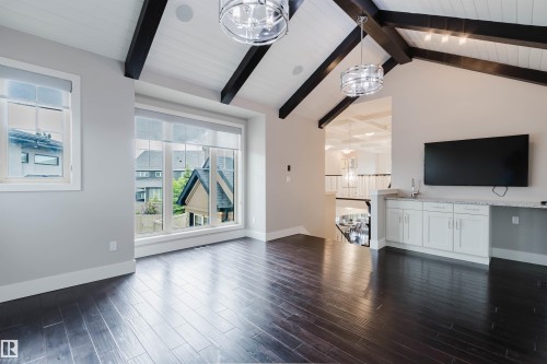 Vaulted ceiling with exposed dark wood beams and white tongue-and-groove paneling - 3435 Keswick Boulevard, Edmonton, AB 