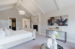 Vaulted ceiling with exposed wood beams and white-washed finish - 