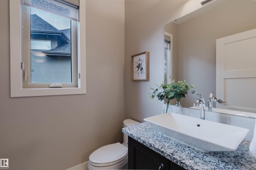 Modern bathroom featuring a rectangular vessel sink, polished chrome faucet, and a speckled countertop - 3435 Keswick Boulevard, Edmonton, AB 