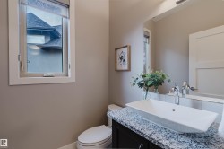 Modern bathroom featuring a rectangular vessel sink, polished chrome faucet, and a speckled countertop - 