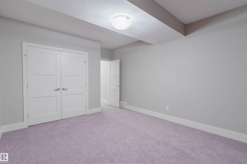 Room featuring violet-hued carpeting, neutral wall paint, and white baseboards - 3435 Keswick Boulevard, Edmonton, AB 