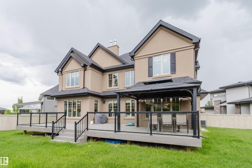 Stucco exterior residence featuring a multi-level deck with glass panel railings - 3435 Keswick Boulevard, Edmonton, AB 