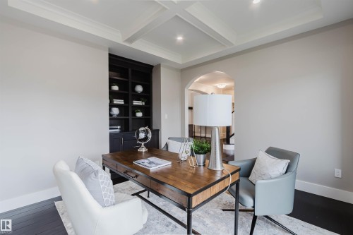 Room featuring dark wood-finish flooring, recessed lighting, and a coffered ceiling - 3435 Keswick Boulevard, Edmonton, AB 